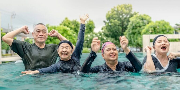 Elderly Group Exercising in Pool at Independent Living Facility